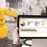 Industry_4.0_concept_.Man_hand_holding_tablet_with_Augmented_reality_screen_software_and_blue_tone_of_automate_wireless_Robot_arm_in_smart_factory_background